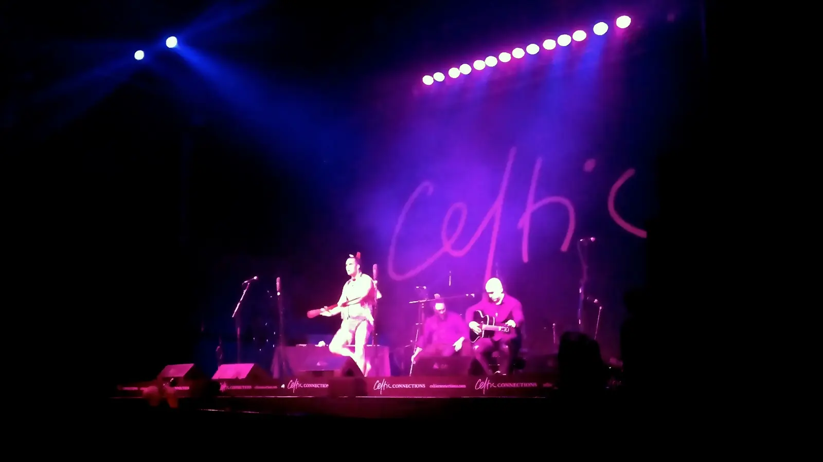 A band plays on a purple lit stage under the Celtic Connections sign in Glasgow in January 2015