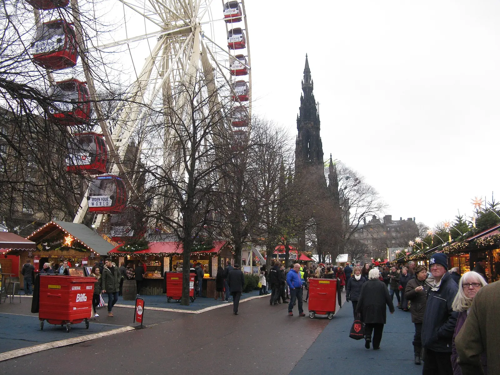 Christmas market stalls and big wheel in East Princes Street Gardens with the Scott Monument behind