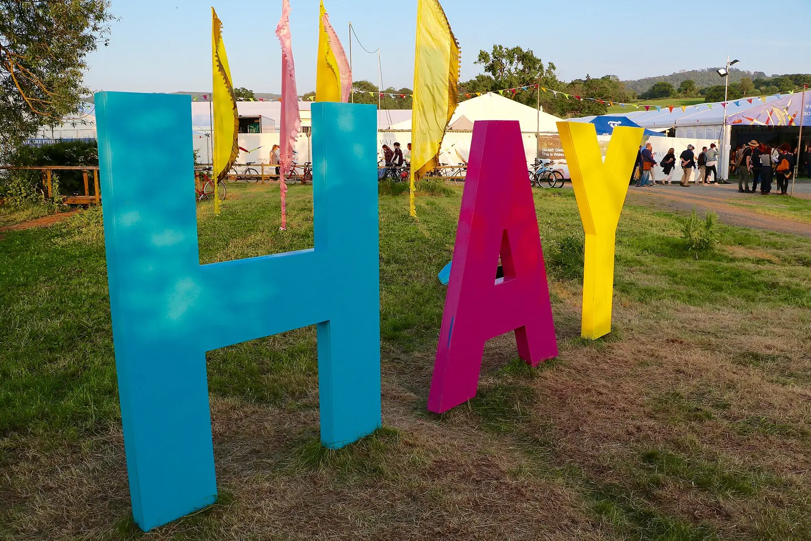 Giant colourful HAY letters on the grass at the Hay Festival site in 2016