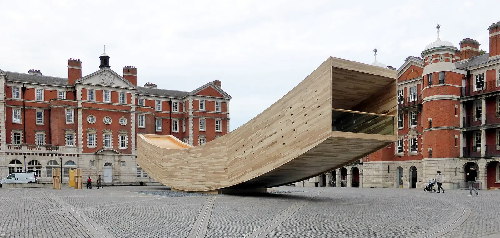 The wooden Smile installation on the square outside the Chelsea College during London Design Festival